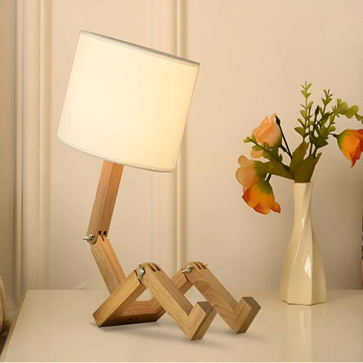 Rilna bendable wooden robot table lamp in playful seated pose