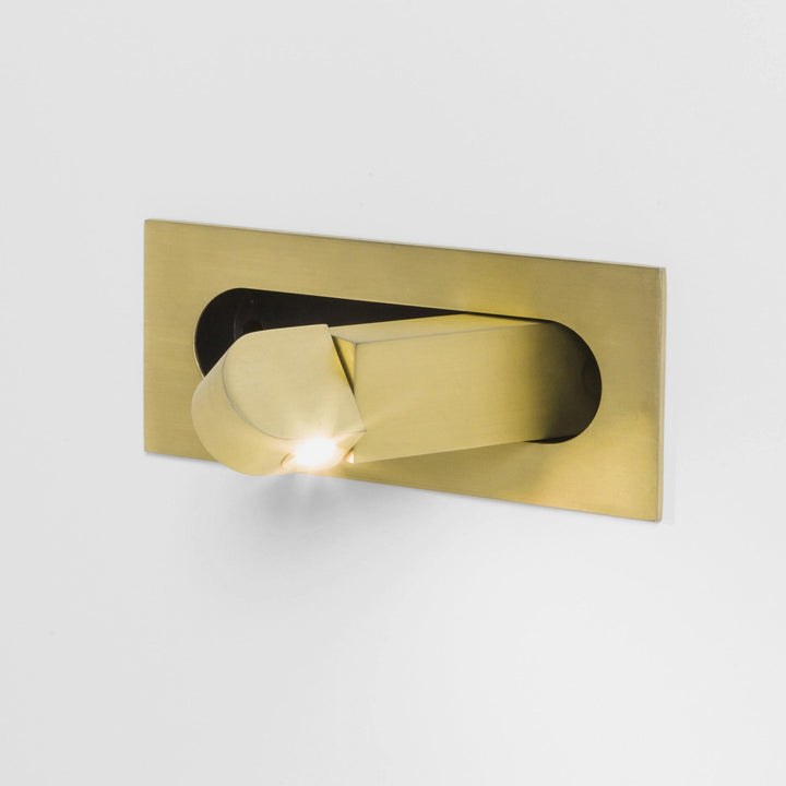 Compact LED wall light in a calm bedroom wall