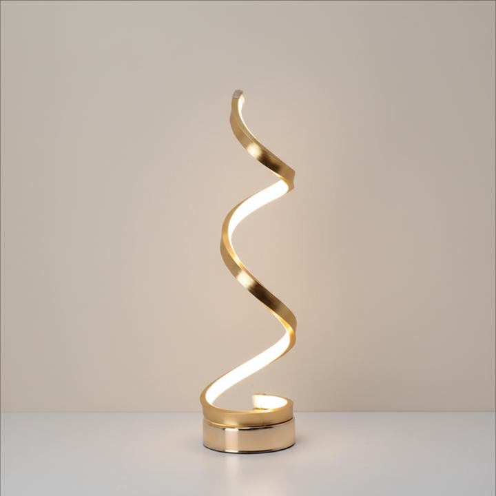 Elya modern LED desk lamp with sculptural wave silhouette on workspace