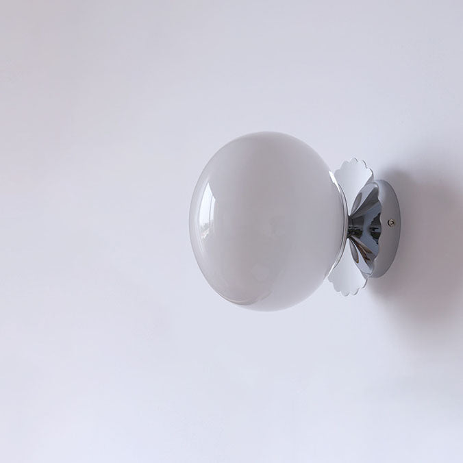 Modern minimalist glass globe wall light lit warm