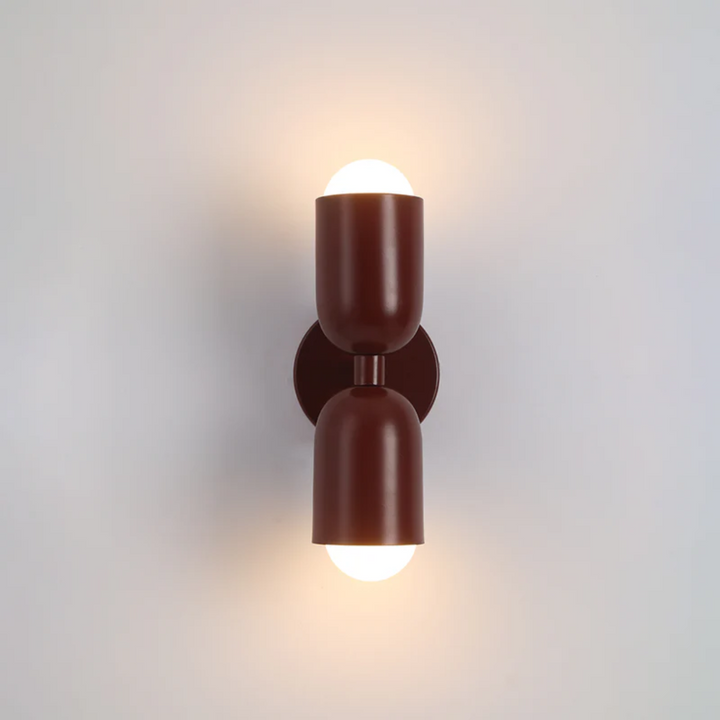 Red Colorwave metal cylinder LED wall sconce in a colourful living room