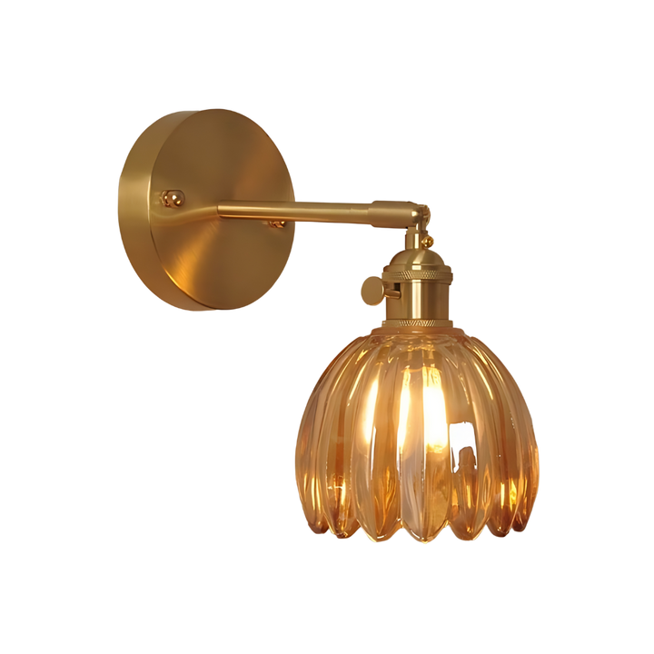 Vintage brass tulip glass wall sconce in mystic amber glowing on a heritage interior wall