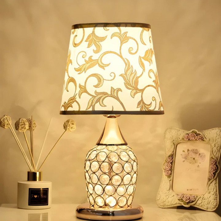 Chanted luxurious LED crystal glow table lamp lit on bedside