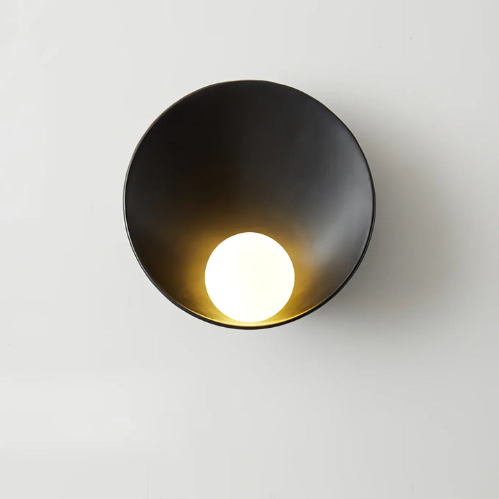 Japandi resin bowl wall light on a dark accent wall