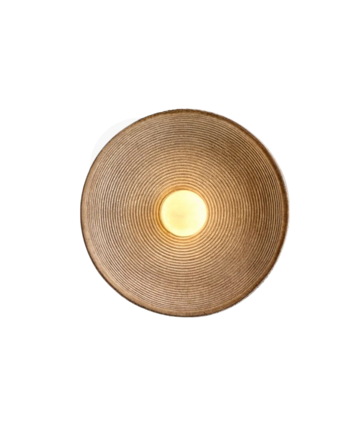 Round wall sconce lit at night showing soft halo glow