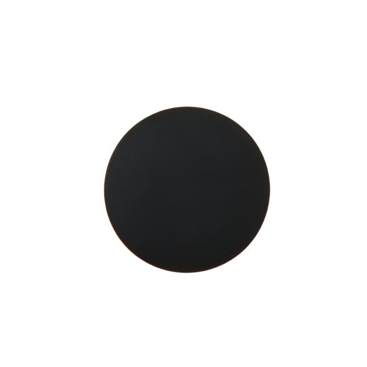 Minimalist round LED outdoor wall sconce in black on exterior wall