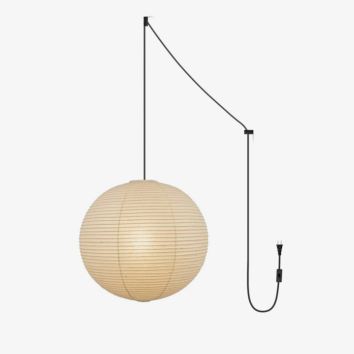 Japanese Paper Pendant Swag Light glowing with warm light in a modern dining room