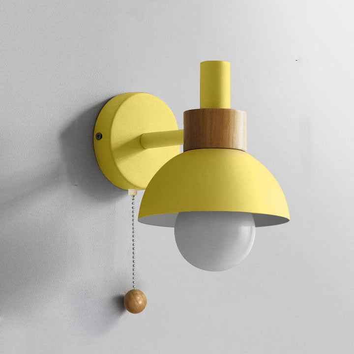 Detail of metal arm and wood disc on the globe sconce