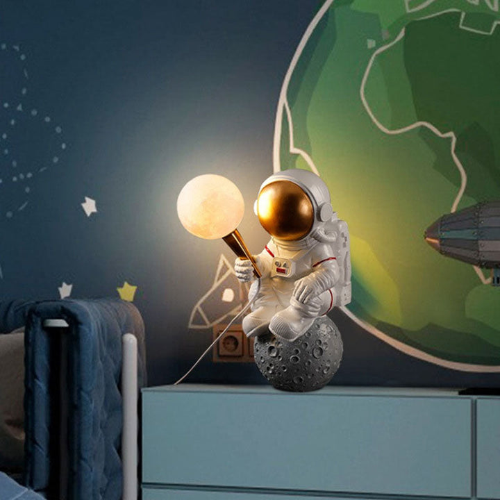Astronaut sconce styled in playroom feature wall