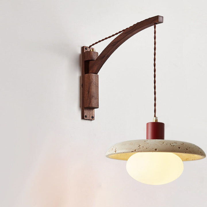 Wabi-sabi wall sconce styled beside artwork on light plaster wall