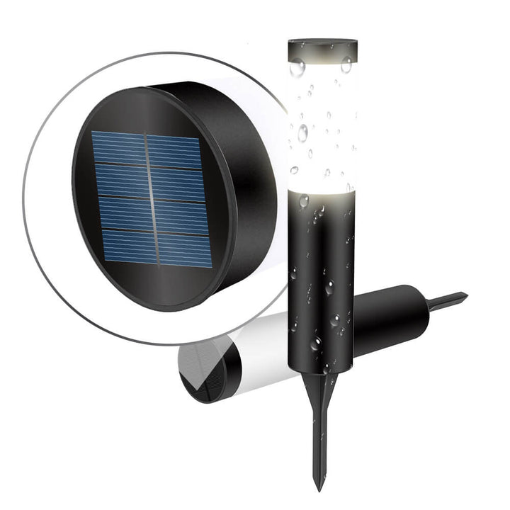 Black cylindrical garden bollard light beside patio edge