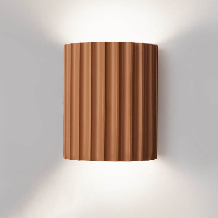 Modern wall sconce orange variant styled in entryway