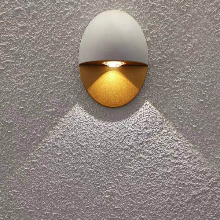 Black gold LED wall sconce lighting a modern UK patio