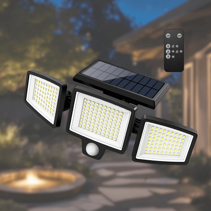 Solar LED 3-head security floodlight mounted high on a garage wall, beams angled to driveway