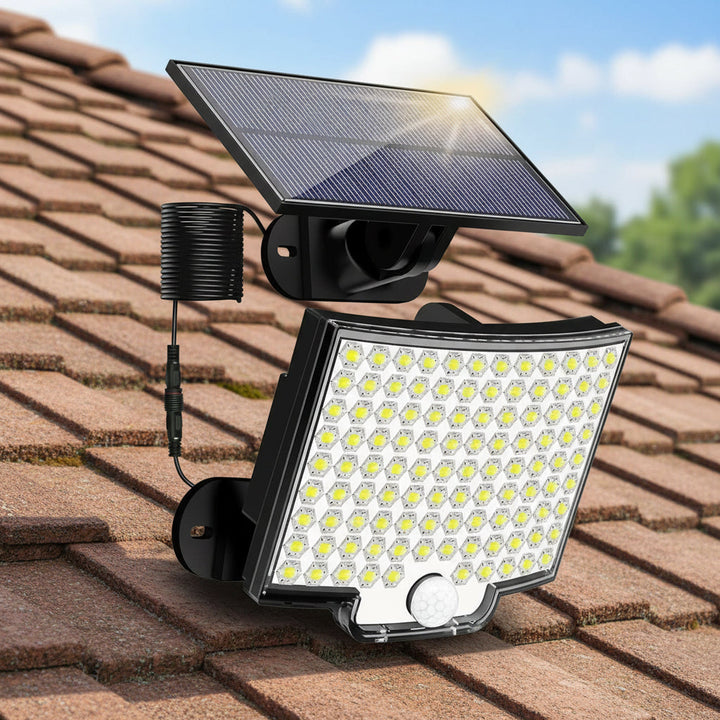 Solar security wall light illuminating driveway at night