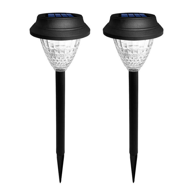 Round solar LED garden stake light in RGB colour-changing mode on a lawn at night