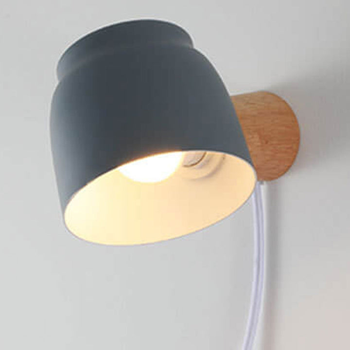 Cylinder wall sconce vertical pair flanking artwork