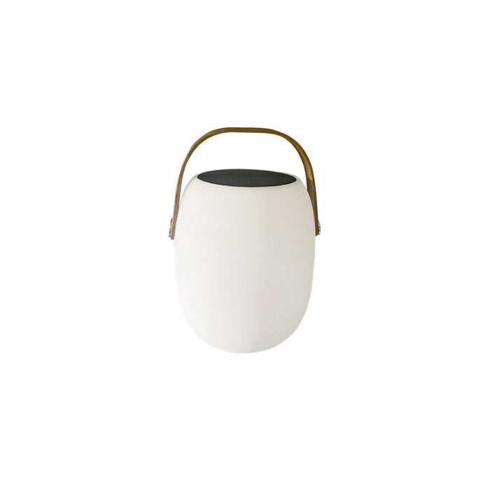 Modern Portable Solar LED Outdoor Lantern glowing on garden table