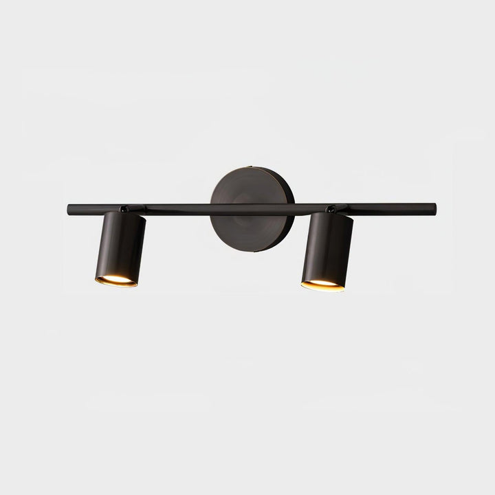 Modern brass double cylinder adjustable wall spotlight in a UK living room