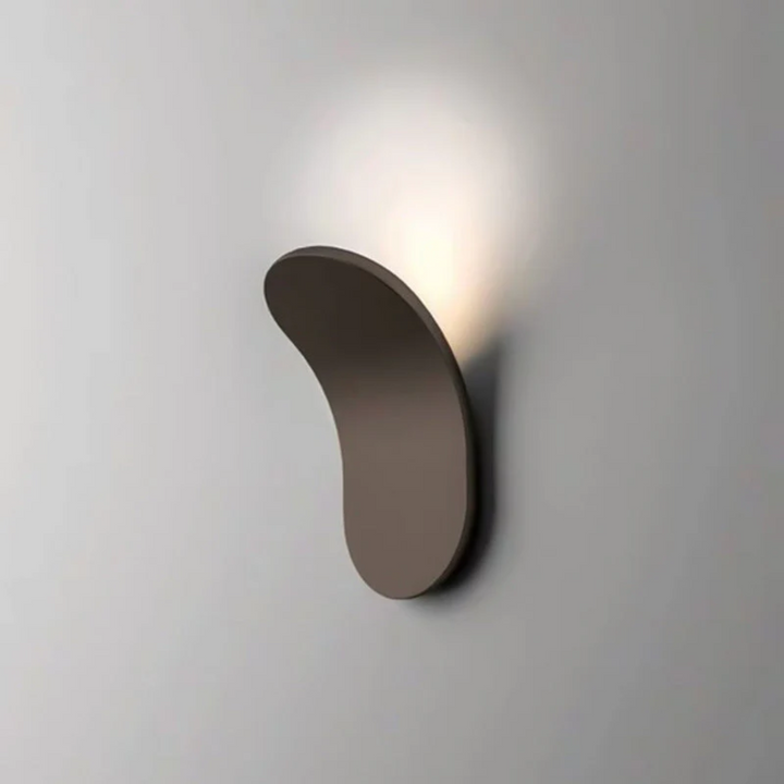 Compact black iron Scandinavian wall light on neutral wall