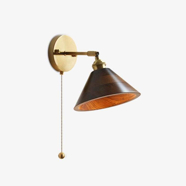 Vintage wooden brass sconce styled beside a bed for reading light