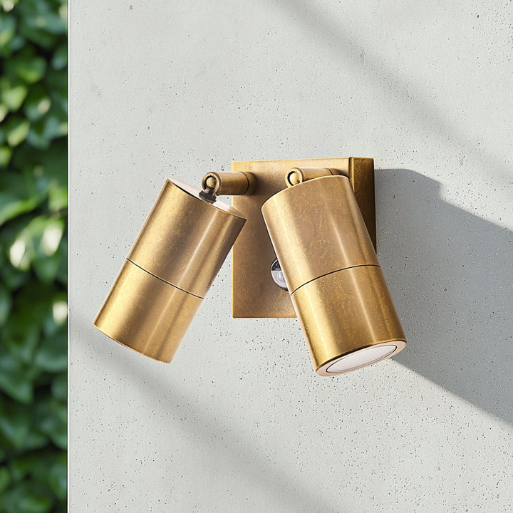 Double Portreath motion sensor wall light in aged brass, lit