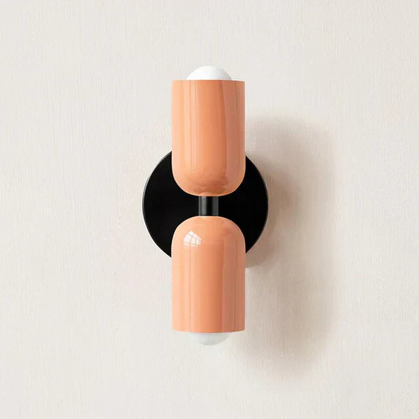 Double-sided LED cylinder wall sconce close-up showing the precision-painted finish