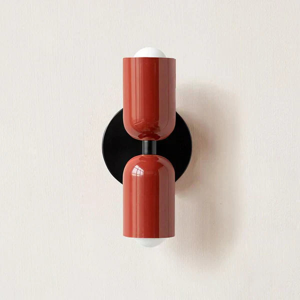 Red DualGlow metal cylinder LED wall sconce as a modern hallway accent