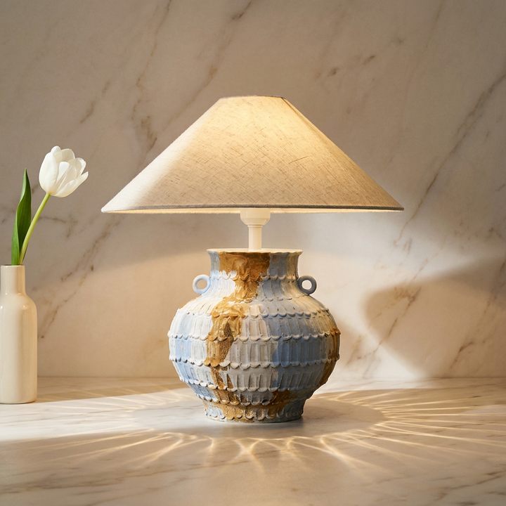 Lumorae mouth-blown sculptural glass table lamp on cream marble with caustic light, hero shot