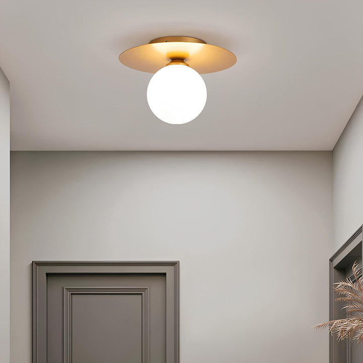 Alura gold sphere LED ceiling light in bedroom setting