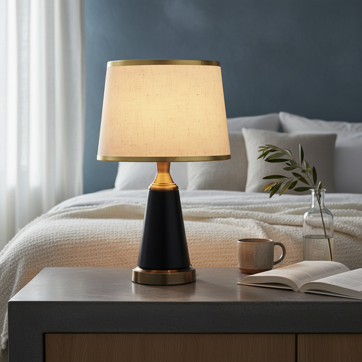 Nordic vintage horn table lamp with linen shade on a pale oak bedside in a Scandinavian bedroom at sunrise.